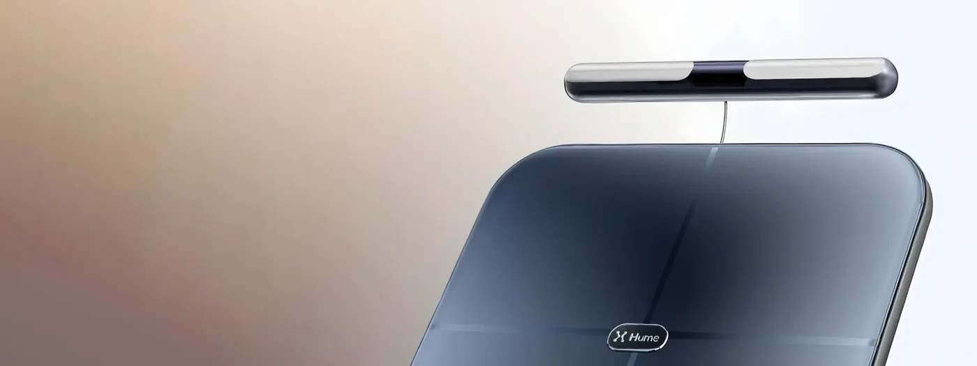 Close-up of Hume Body Pod scale with detachable handlebar sensor, showcasing sleek design for advanced body composition measurement.
